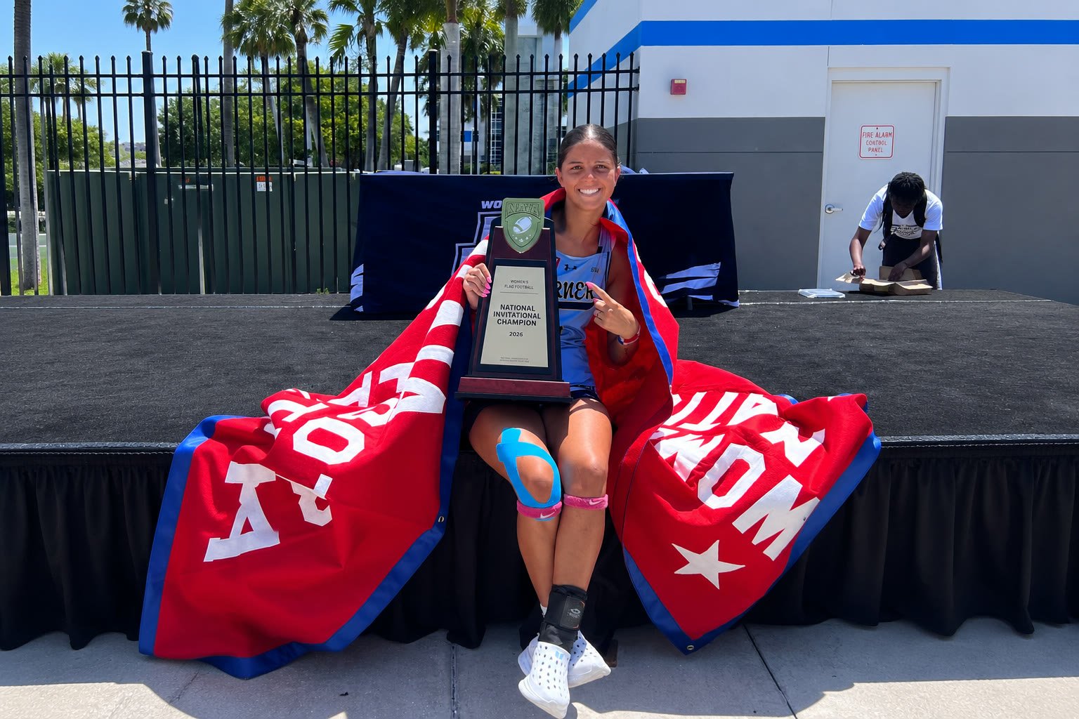 Kayleigh Thomas with the 2026 National Invitational Champion trophy